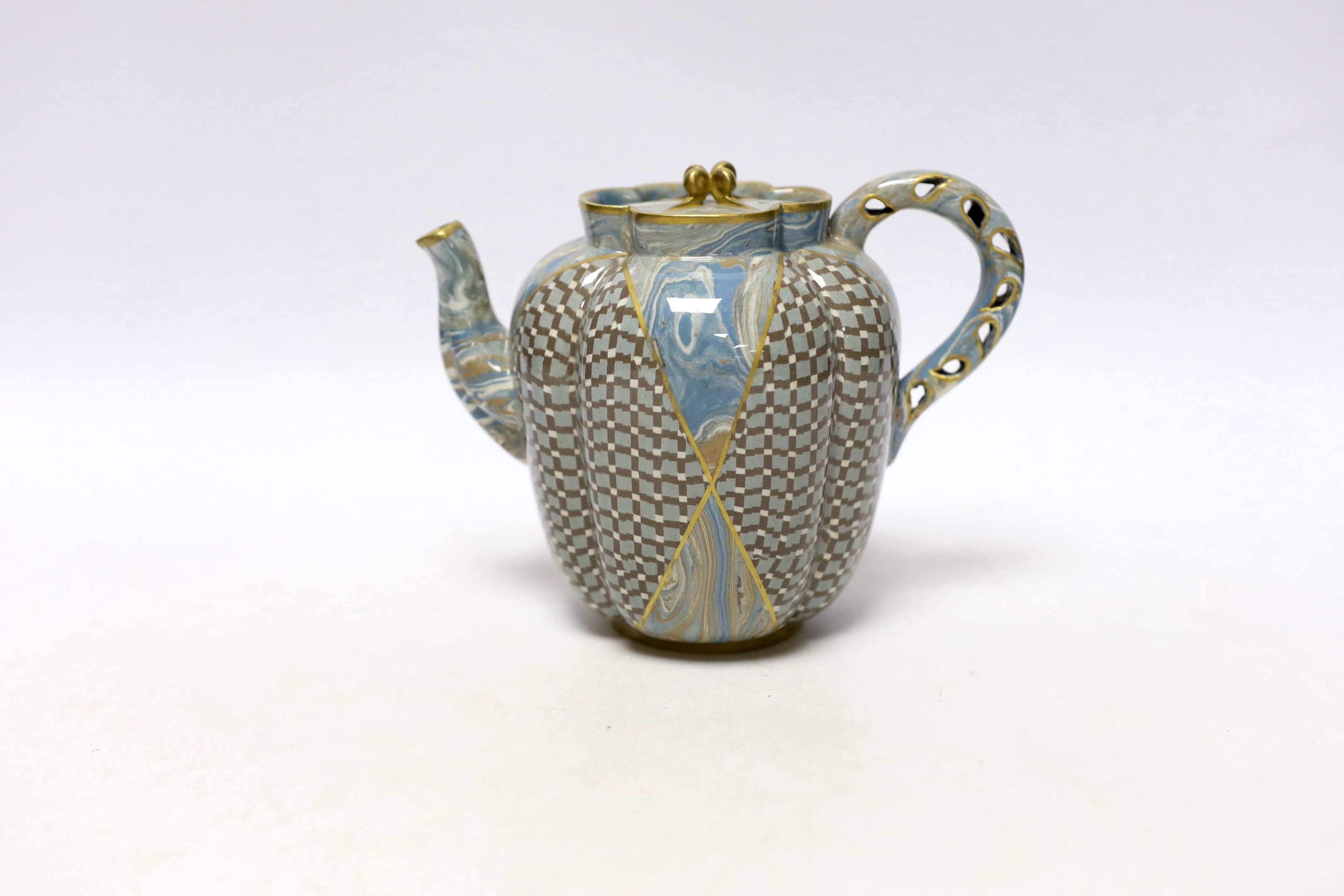 A good Doulton & Rix's patent Marqueterie ware teapot, c.1887, of quatrelobed form with 'teardrop' pierced handle, alternating panels of lattice and marbling, black printed mark and inscribed in black 646B, 16.5cm wide